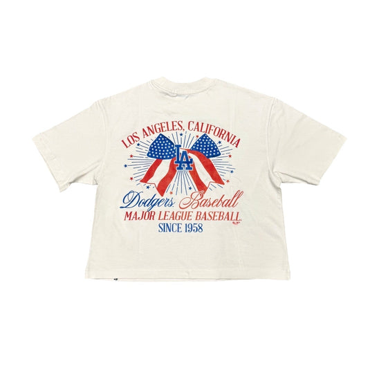 Back view of a women's relaxed fit '47 Brand Los Angeles Dodgers crop top featuring a patriotic red, white, and blue USA bow graphic, fireworks, and vintage baseball-inspired artwork celebrating Los Angeles, California.