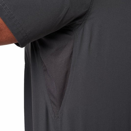 Close-up of a dark gray collared button up with an underarm mesh gussets on a white background