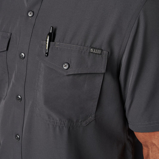 Close-up of a dark gray collared button up shirt with a pen in a pocket