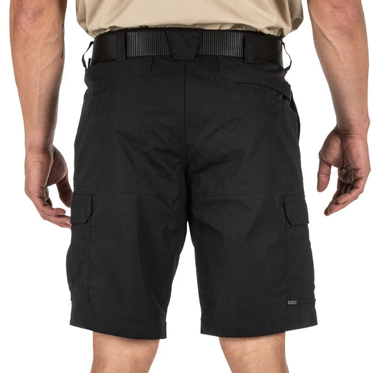 Back of person wearing black cargo shorts on a white background