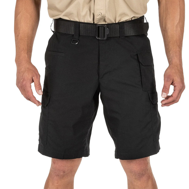 Load image into Gallery viewer, Black tactical shorts worn by a person on a white background
