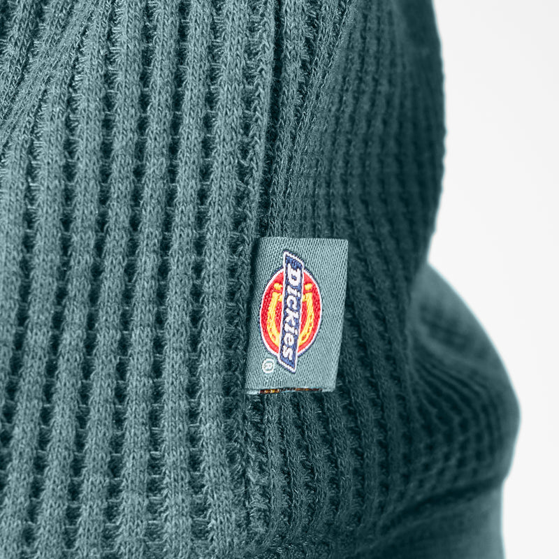 Load image into Gallery viewer, Side logo and waffle knit close up of the Dickies Women's Thermal Crewneck Shirt - Balsam Heather - This balsam fir green women's thermal shirt features a classic waffle knit fabric thermal is perfect for wearing on its own or layered under your favorite Dickies hoodies and jackets.
