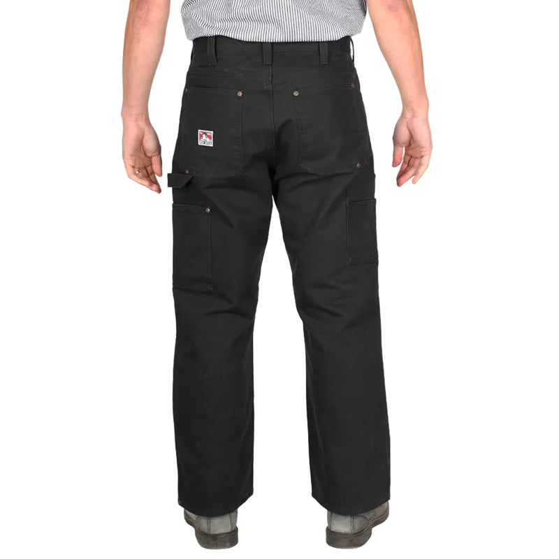 Load image into Gallery viewer, Person wearing black pants with two back pockets, hammer loop on the right leg, and side pockets on each leg on a white background
