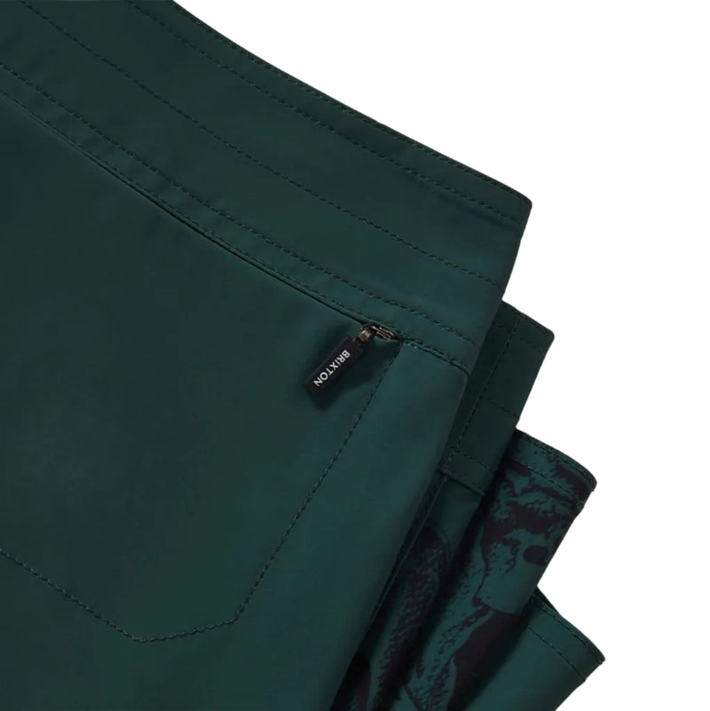 Load image into Gallery viewer, Green boardshorts with a Brixton brand label on the hidden back right pocket zipper.
