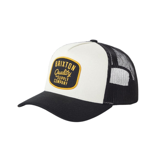 Black and off white mesh trucker cap with a yellow and black Brixton logo patch.