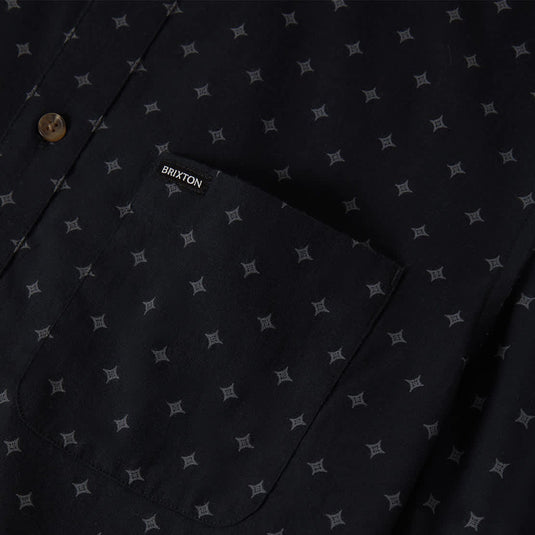 Black short-sleeve button-up woven shirt with subtle grey diamond print and left chest pocket with 