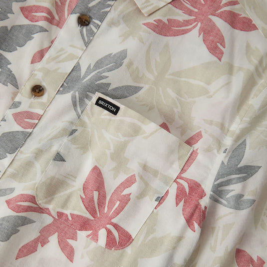 Off white short sleeve button up shirt with faded black and faded red floral print pattern. Left chest pocket has small 