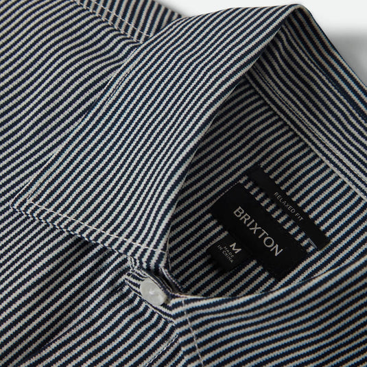 Close-up of a striped shirt collar with woven Brixton size label