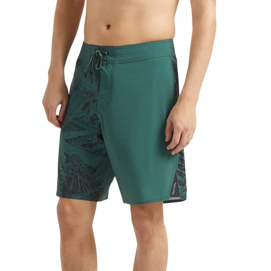 Green board shorts worn by a person who is 5'11" tall and wearing a size 32