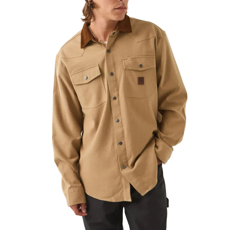 Load image into Gallery viewer, A man wearing a tan long-sleeve button-up shirt with a brown collar, black pants, and a black beanie with a gray graphic, standing against a plain off-white studio background.
