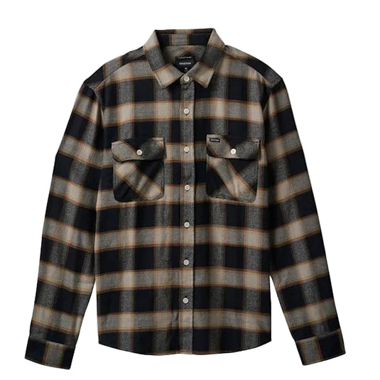 A long-sleeve button-up plaid shirt in black, brown, and beige, featuring two chest flap pockets with snap closures, displayed on a light gray background.