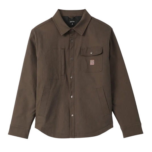 A dark brown Brixton button-up shirt jacket with a pointed collar, a chest pocket with a snap button and the signature Brixton brand patch, and two front flap pockets, shown flat on a light gray background.