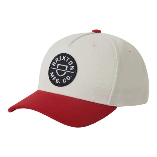 Baseball cap with red brim and beige top on a white background