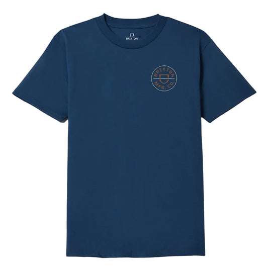 A navy blue short-sleeve crewneck t-shirt with a circular embroidered logo on the left chest, displayed flat against a light gray background.