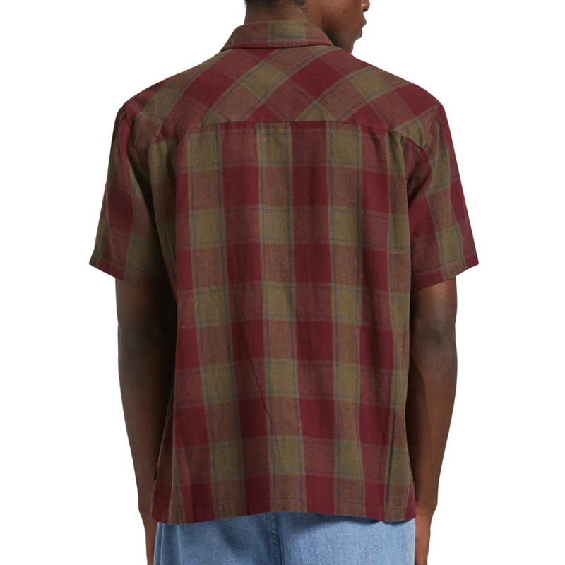 Load image into Gallery viewer, A man wearing a short-sleeve plaid button-up shirt in burgundy and olive green, shown from the back against a light gray background.

