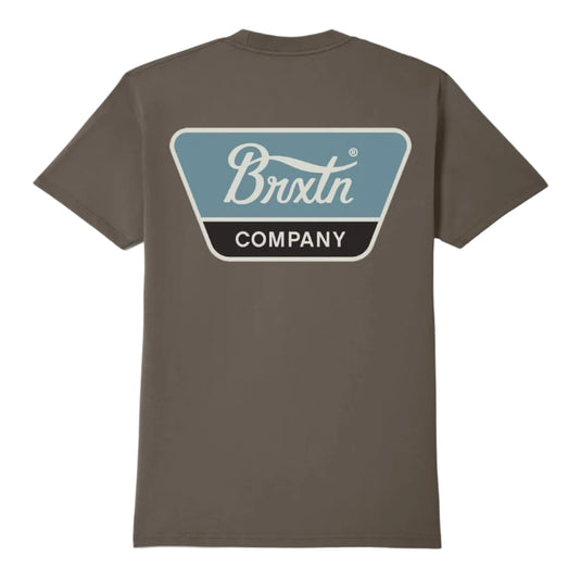 A brown short-sleeve t-shirt shown from the back, featuring a large graphic print on the upper back with a light blue and black shield shape containing the text 'Brixtn COMPANY'.