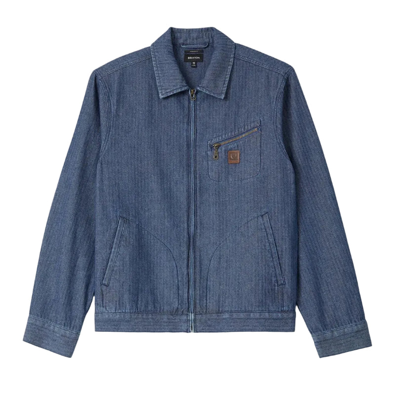 Load image into Gallery viewer, A blue denim jacket with a zippered front, pointed collar, and a small brown leather Brixton logo patch on the chest pocket, displayed flat against a white background.
