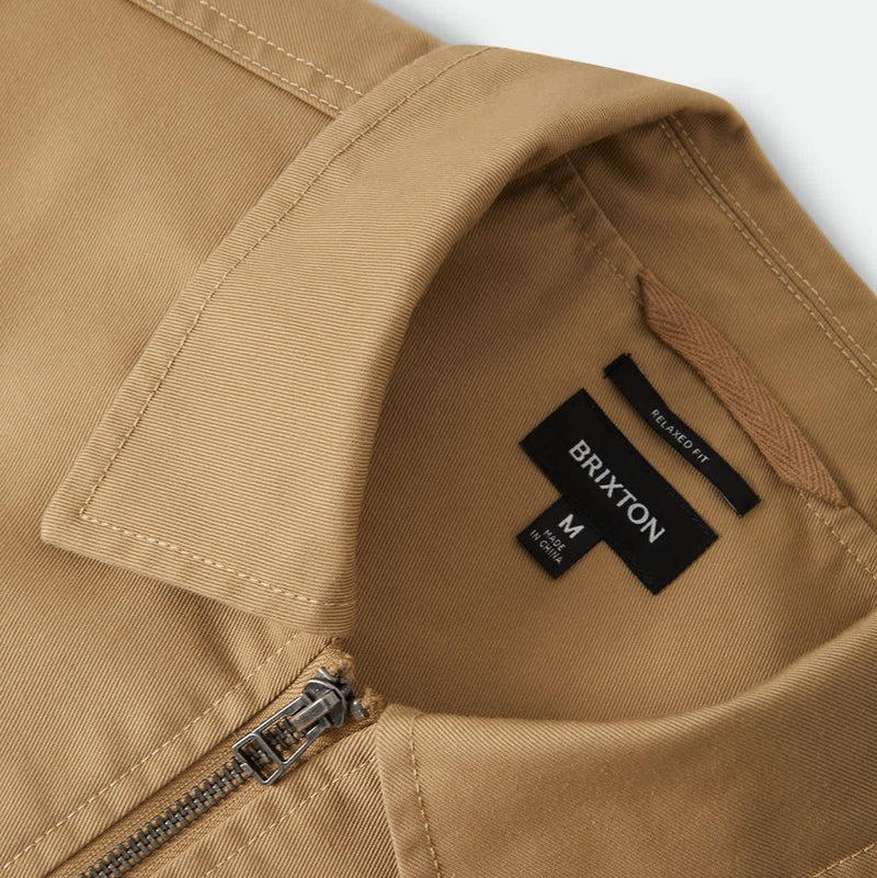 Load image into Gallery viewer, Closeup of the collared neckline of a Khaki Brixton zipper jacket 
