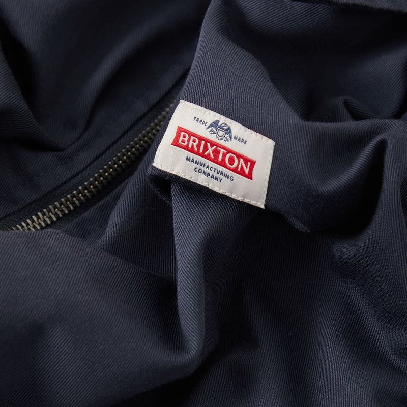Load image into Gallery viewer, Closeup of the Brixton Trademark patch on the Brixton garage jacket
