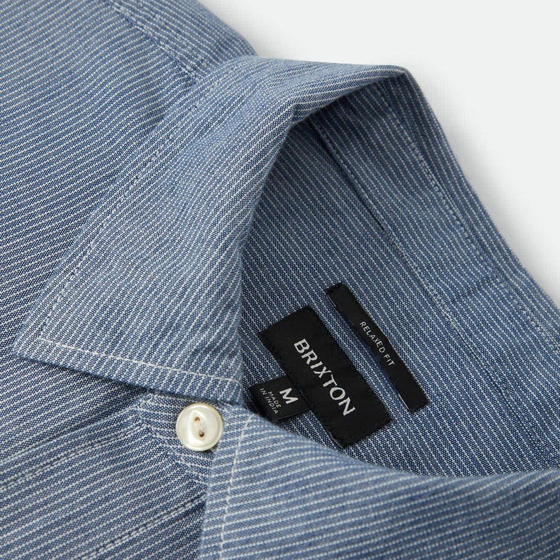 Load image into Gallery viewer, Closeup on the collar of a light blue striped Brixton button up shirt
