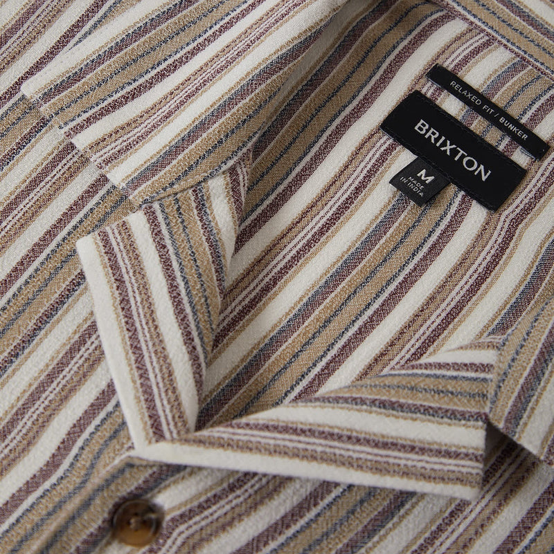Load image into Gallery viewer, Close-up of the collar of a striped button up shirt with a Brixton label
