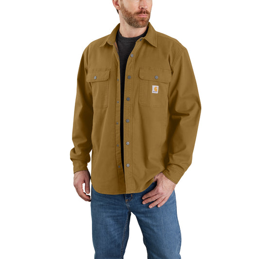 A model wearing the Carhartt TJ5419 Fleece Lined Canvas Shirt Jac in a dark mustard brown color.