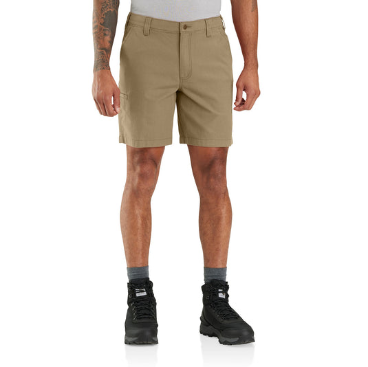 Person wearing beige shorts and black hiking boots on a white background