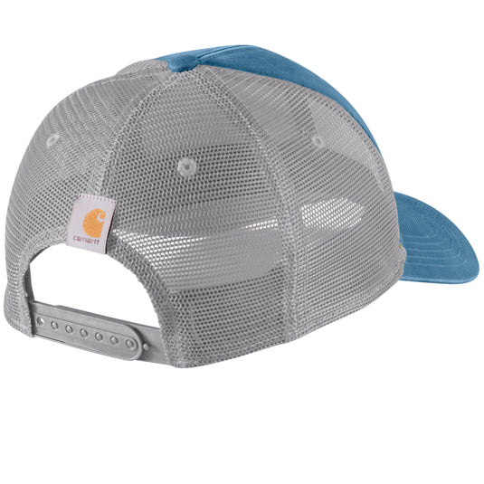Rear three-quarter view of a Carhartt trucker cap with a gray mesh back, blue visor, and blue crown top, on a white background.