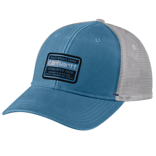 A blue and gray trucker hat with a blue front panel and visor, and a gray mesh back. A black and white Carhartt patch is on the front.