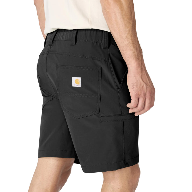 Load image into Gallery viewer, Person wearing the Black Carhartt 8" Force Phoenix Short with a Carhartt logo patch on the right back pocket and a cell phone pocket on the same leg
