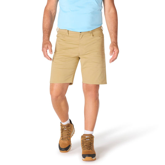 Person wearing beige shorts and brown boots on a white background
