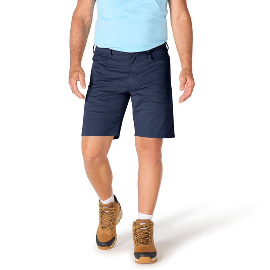 Person wearing navy shorts and brown boots on a white background