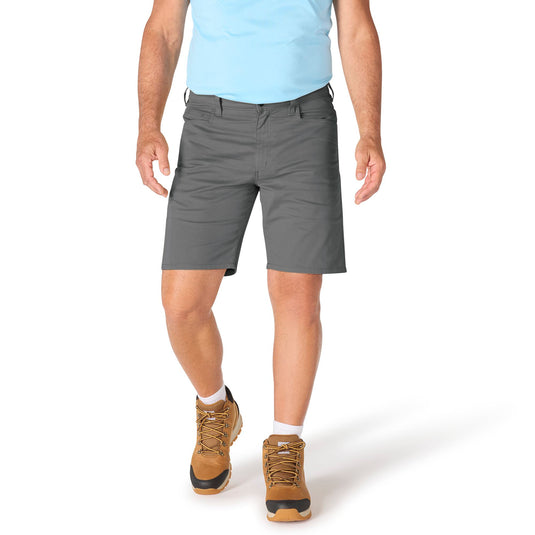 Person wearing gray shorts and brown hiking boots on a white background