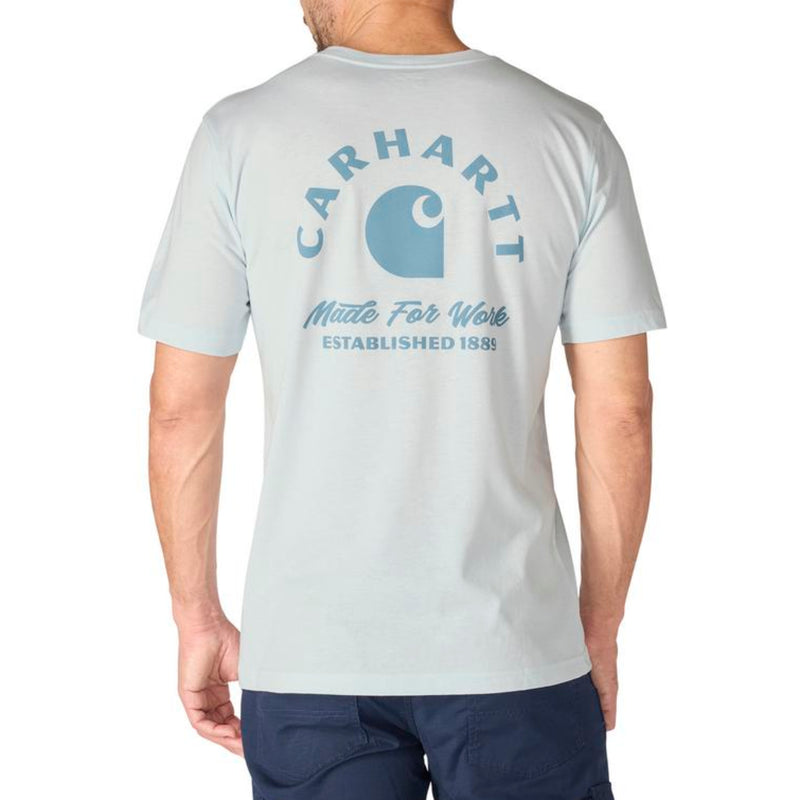 Load image into Gallery viewer, Man wearing a light blue gray Carhartt t-shirt with a logo and "Made For Work Established 1889" on the back against a white background
