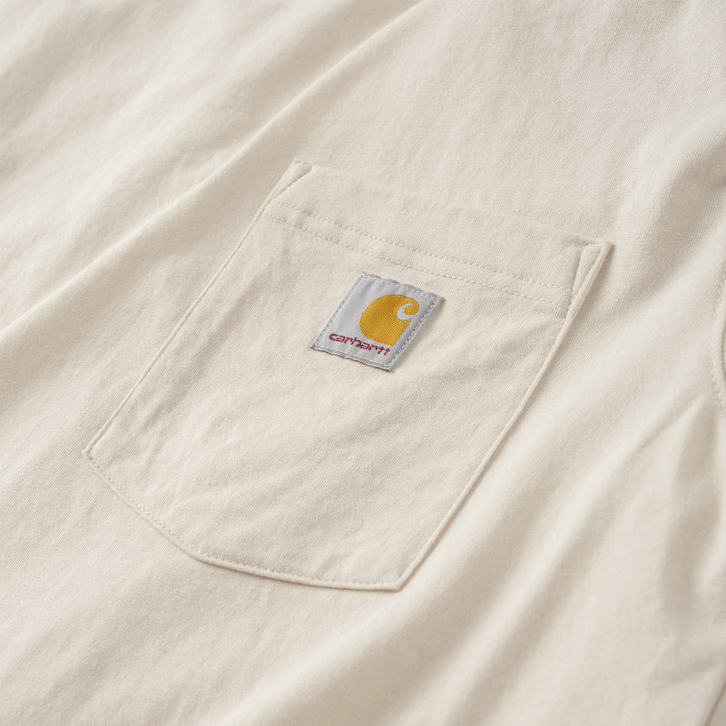 Load image into Gallery viewer, Close-up of a cream-colored Carhartt pocket with the brand's signature yellow logo patch on the chest.
