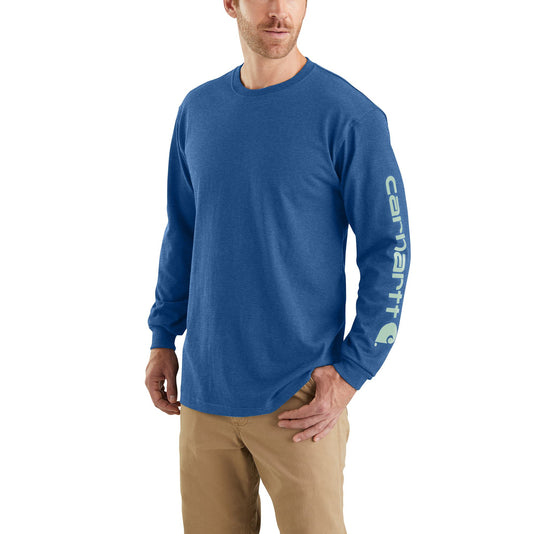 Man wearing a blue long-sleeve shirt with a Carhartt brand logo on a white background.