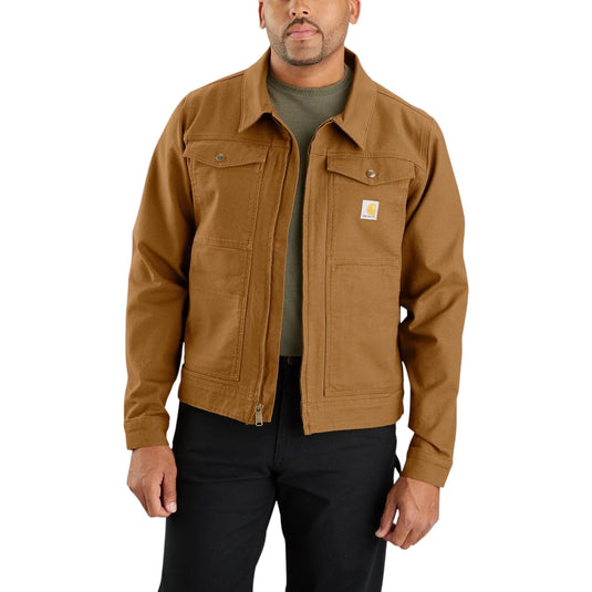 A man wearing a brown Carhartt work jacket over a dark green shirt and black pants, shown from the waist up against a plain white background.