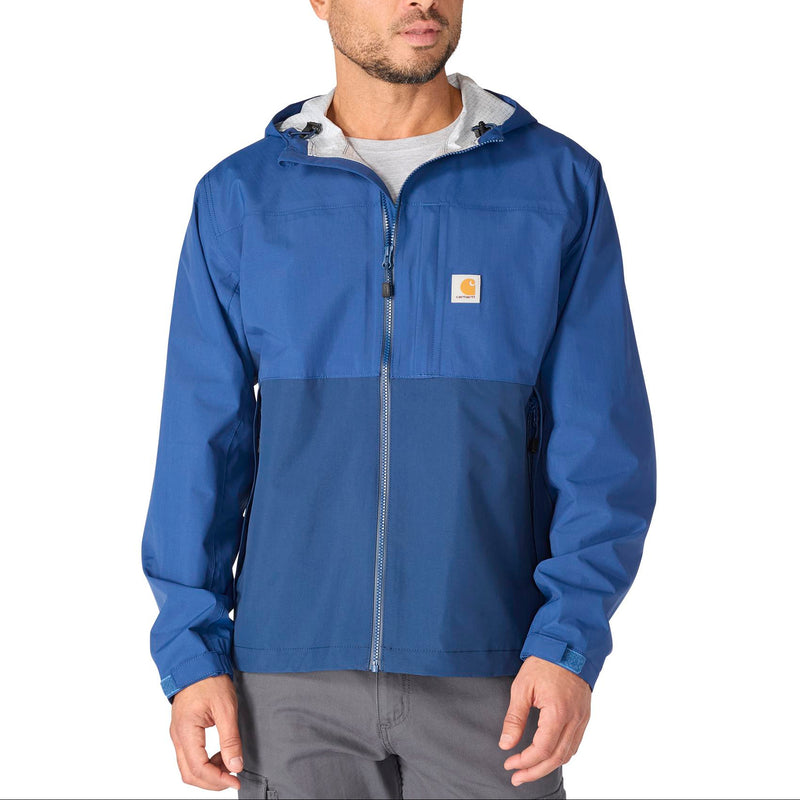 Load image into Gallery viewer, A man wearing a blue and navy colorblock hooded jacket by Carhartt, featuring a full-zip front and the signature brand patch on the chest, set against a plain white background.
