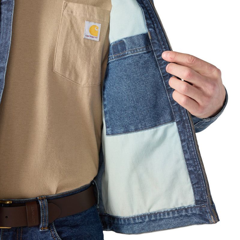 Load image into Gallery viewer, Close-up of a person wearing a Carhartt jacket with a visible brand logo.
