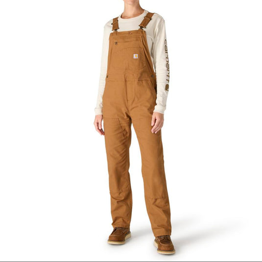 Female wearing brown Carhartt overalls on a white background