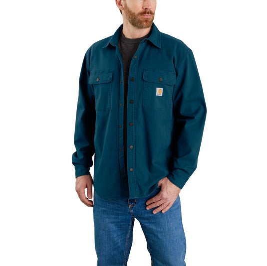 A model wearing the Carhartt TJ5419 Fleece Lined Canvas Shirt Jac in the bright Night Blue (H69) color.