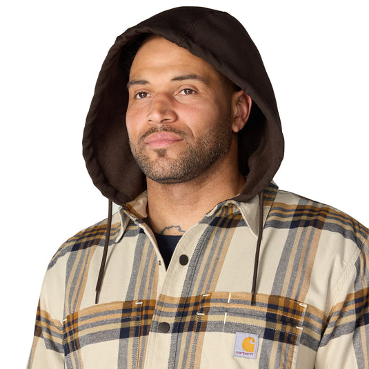 Closeup a man wearing the hood of a Carhartt plaid shirt jac flannel