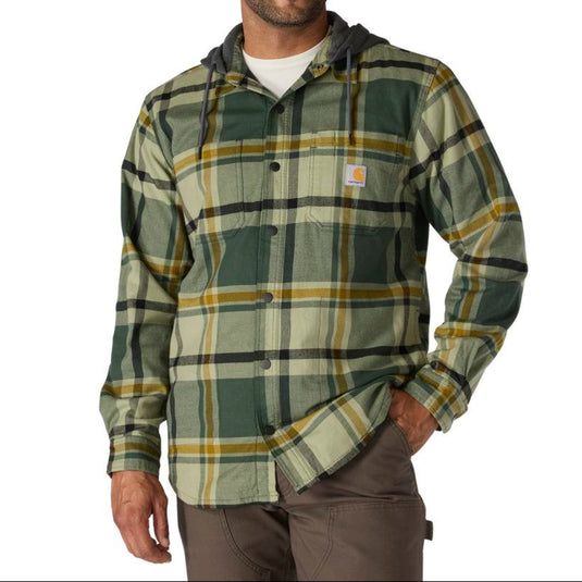 Man wearing a forestry green plaid shirt with a visible Carhartt brand logo on the left chest pocket on a white background