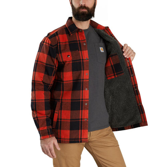 Man wearing a red and black plaid shirt with a gray interior, standing against a white background.