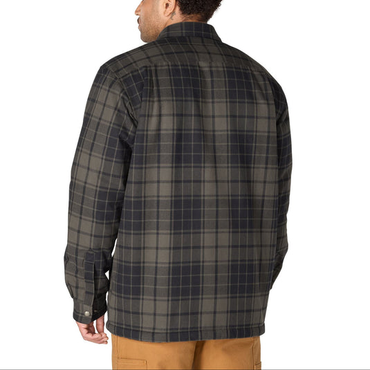 Back shot of a man wearing a navy and gray plaid flannel shirt jacket. 
