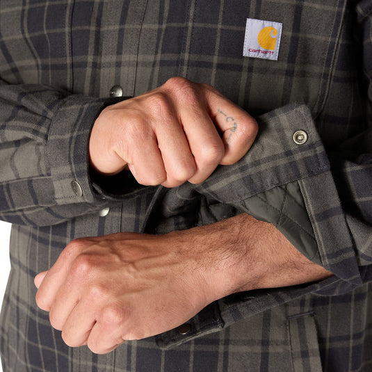 Closeup of a the cuffs on the Carhartt Plaid Sherpa lined flannel with a snap button closure. 
