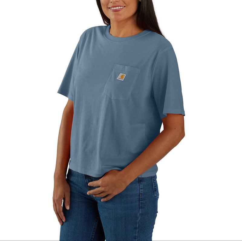 Load image into Gallery viewer, Woman wearing a blue t-shirt with a visible Carhartt logo on a white background
