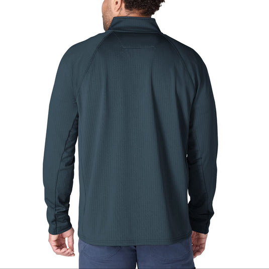 A man viewed from the back wearing a dark teal ribbed quarter-zip pullover jacket and blue pants, set against a plain white background.