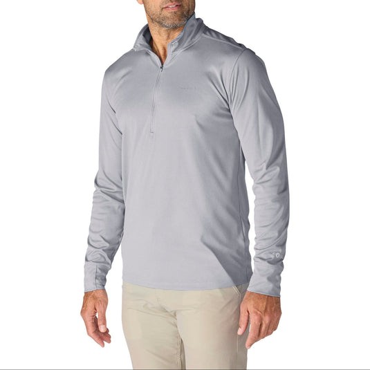 Man wearing a light gray long-sleeve quarter zip shirt with "carhartt" spelt out on the left chest area on a white background