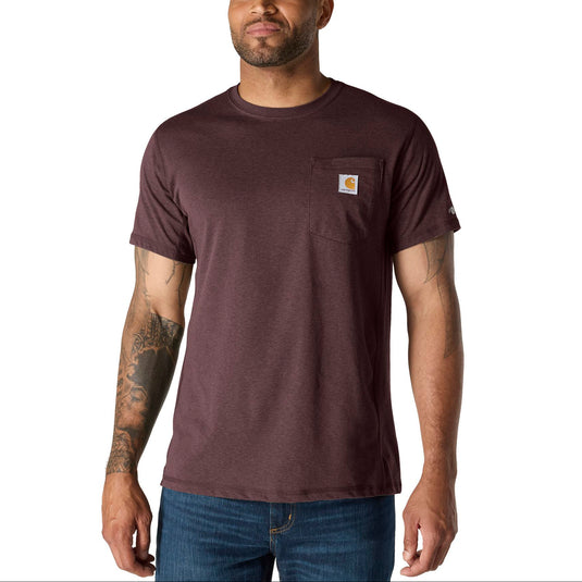 A man wearing a dark red Carhartt short-sleeve pocket t-shirt and blue jeans, standing against a plain white background.